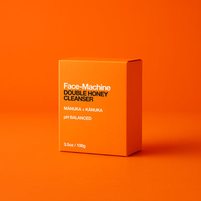 Orange box of Face-Machine Double Honey Cleanser on an orange background. facial cleanser, clean skin, skin repair, gift for wife, skincare routine, gentle face wash, hydrating cleanser, anti-aging skincare, daily cleanser, sensitive skin care, skin revitalization, luxury skincare gift, natural cleanser, deep pore cleanse, skin renewal, manuka honey